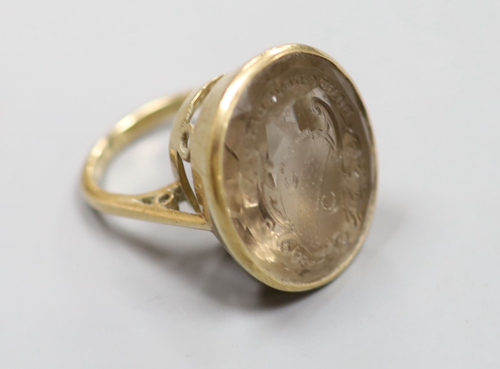 A 9ct and oval citrine set seal ring, the matrix carved with motto and crest